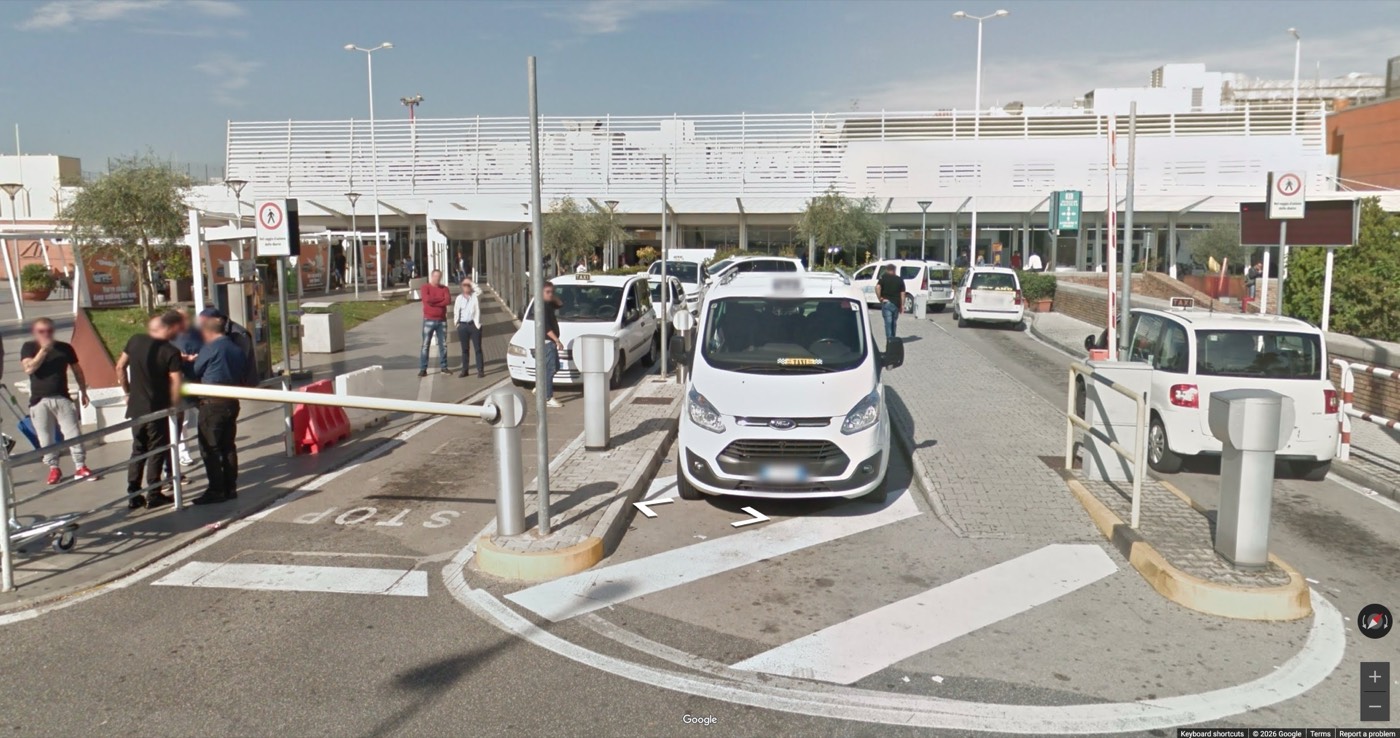 White taxis queued at the barrier of the Naples airport taxi rank